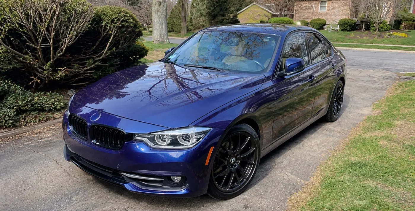 AI-generated view of a 2016 BMW 328i xDrive with Enkei Raijin wheels