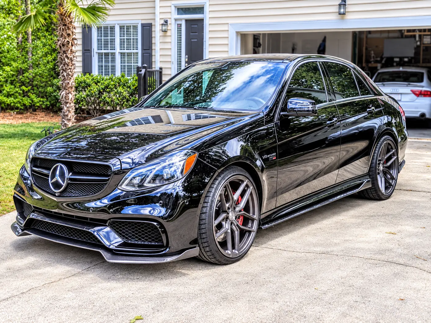 AI-generated view of a 2014 Mercedes-Benz E63 S AMG with Stance SF03 wheels