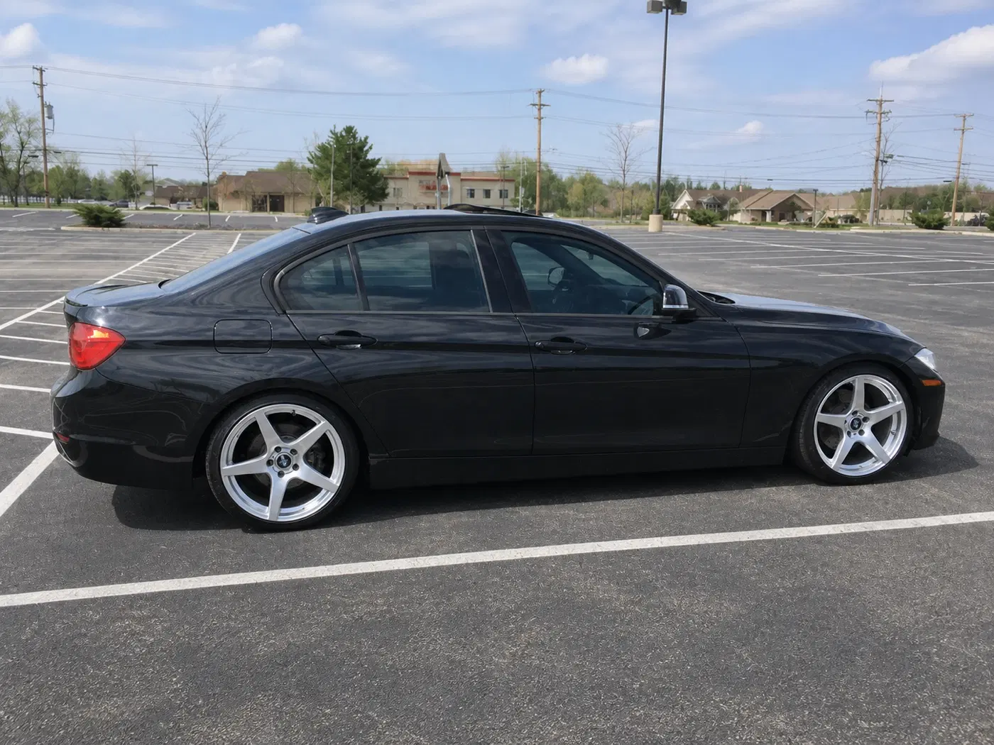 AI-generated view of a 2012 BMW 328i Sport Line with VMR V705 wheels