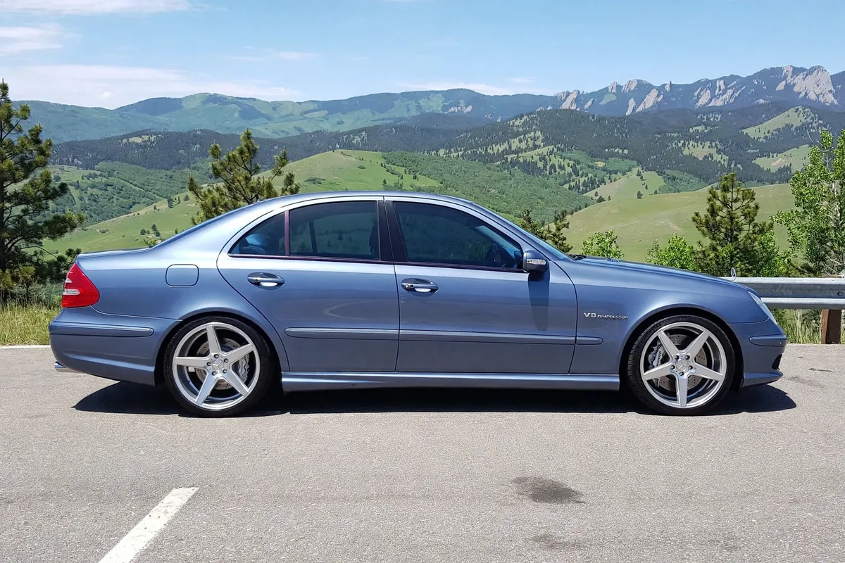 AI-generated view of a 2003 Mercedes-Benz E55 AMG with KMC District wheels