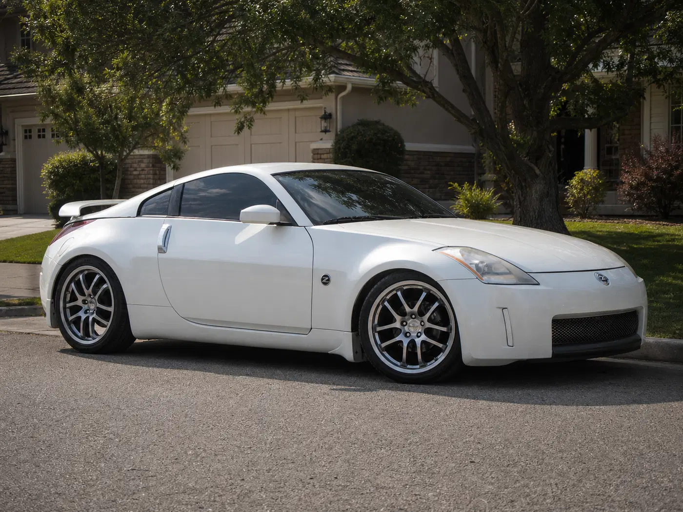 AI-generated view of a 2003 Nissan 350Z Touring with Rays Engineering Forged 2005 G35c wheels